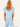 Woman wearing a light blue dress with text indicating her height and dress size.