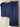 Navy blue ribbed top and pants on hangers against a textured beige wall.
