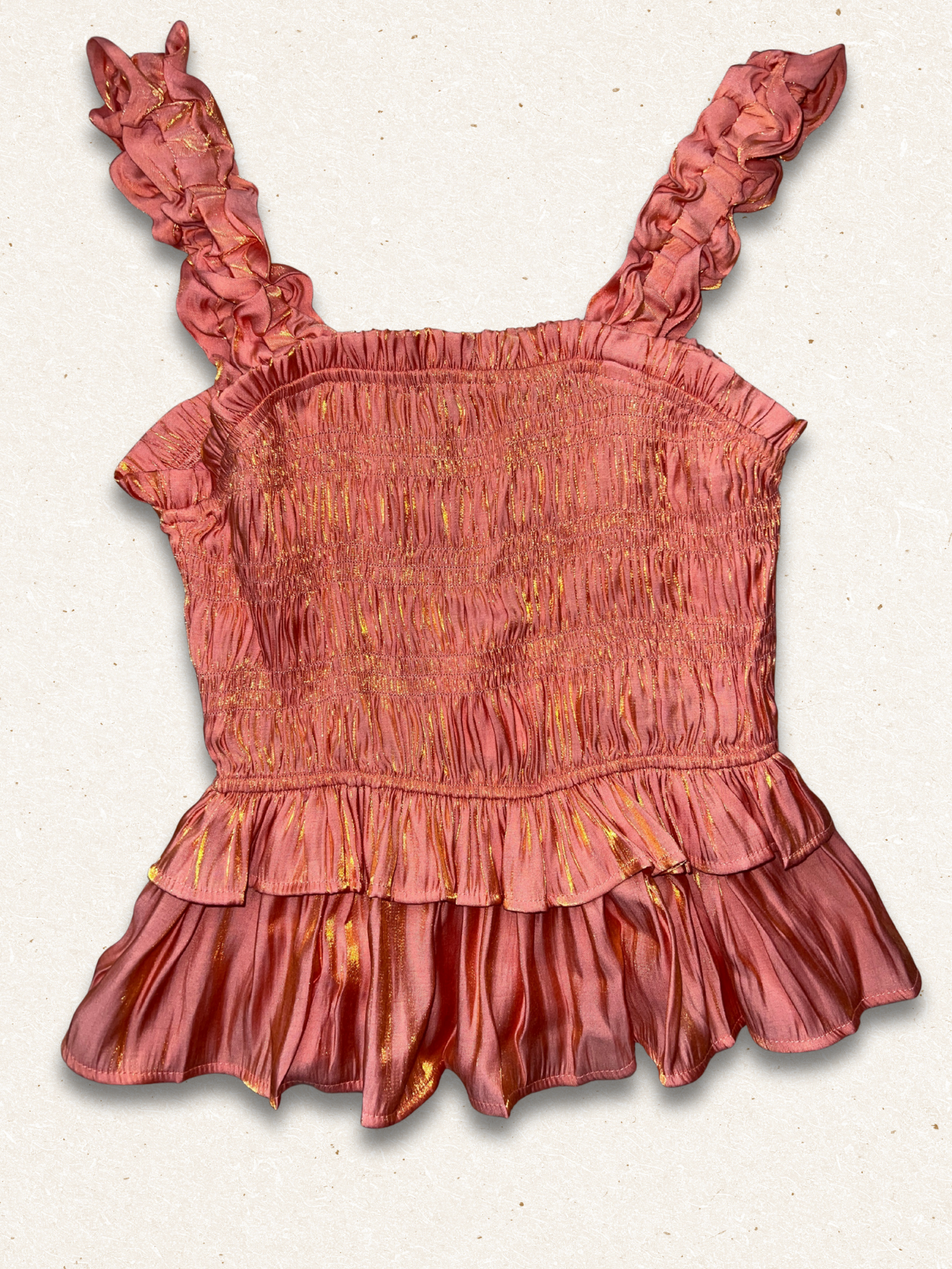 Pink ruffled top on a light gray background