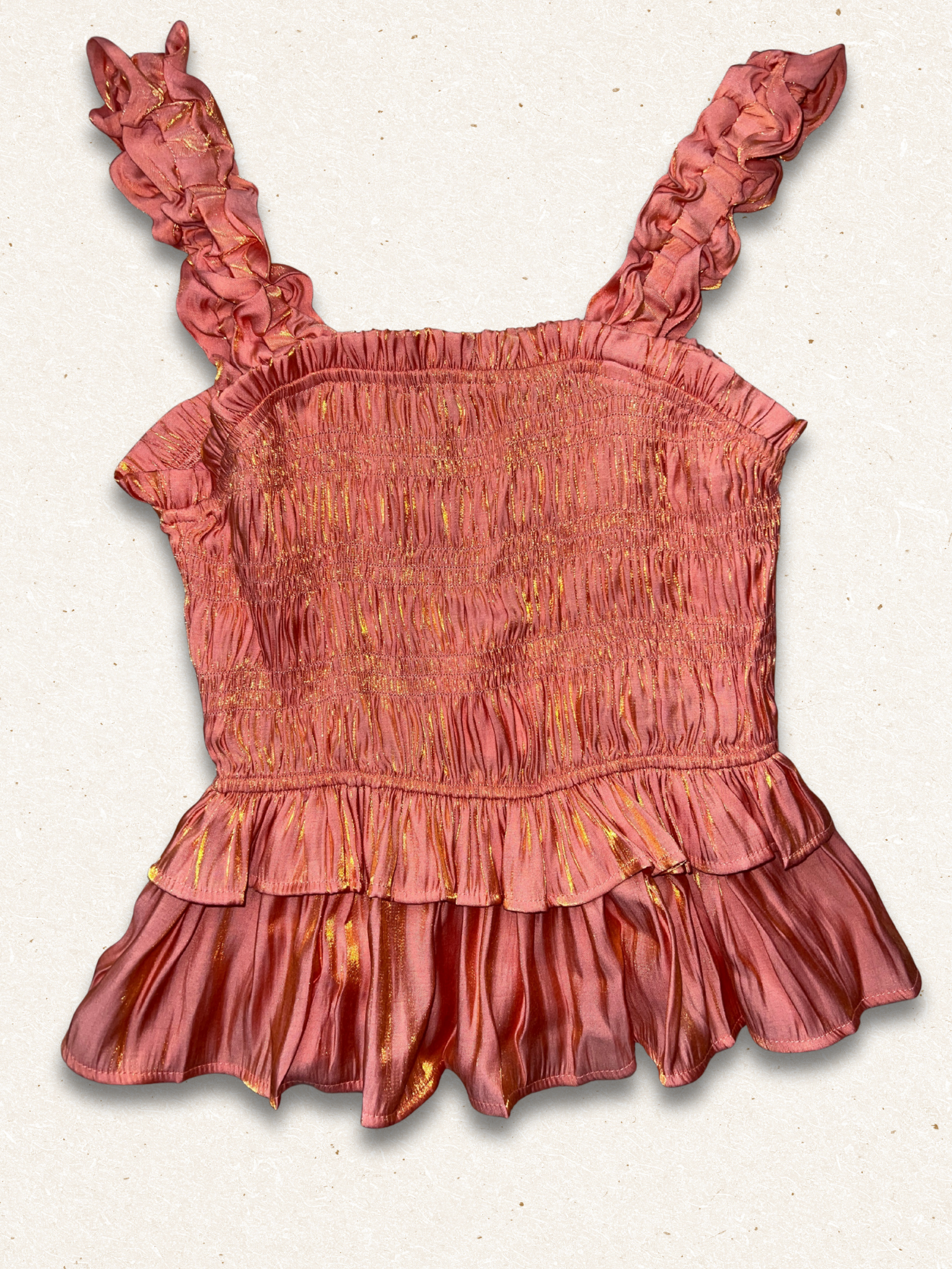 Pink ruffled top on a light gray background