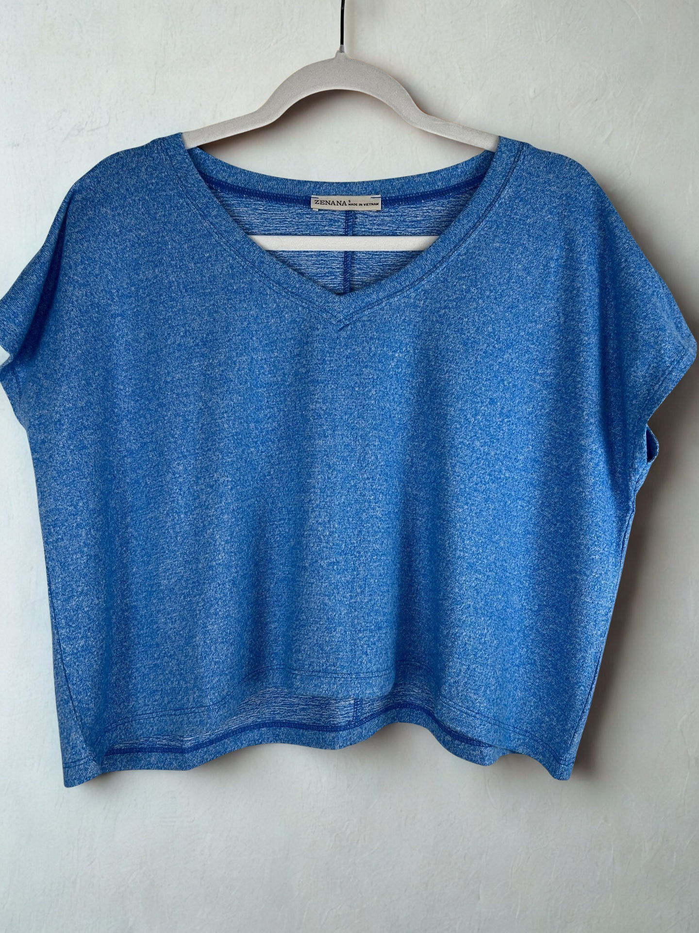 /Blue/ Blue crop top on a hanger against a white background