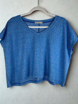/Blue/ Blue crop top on a hanger against a white background