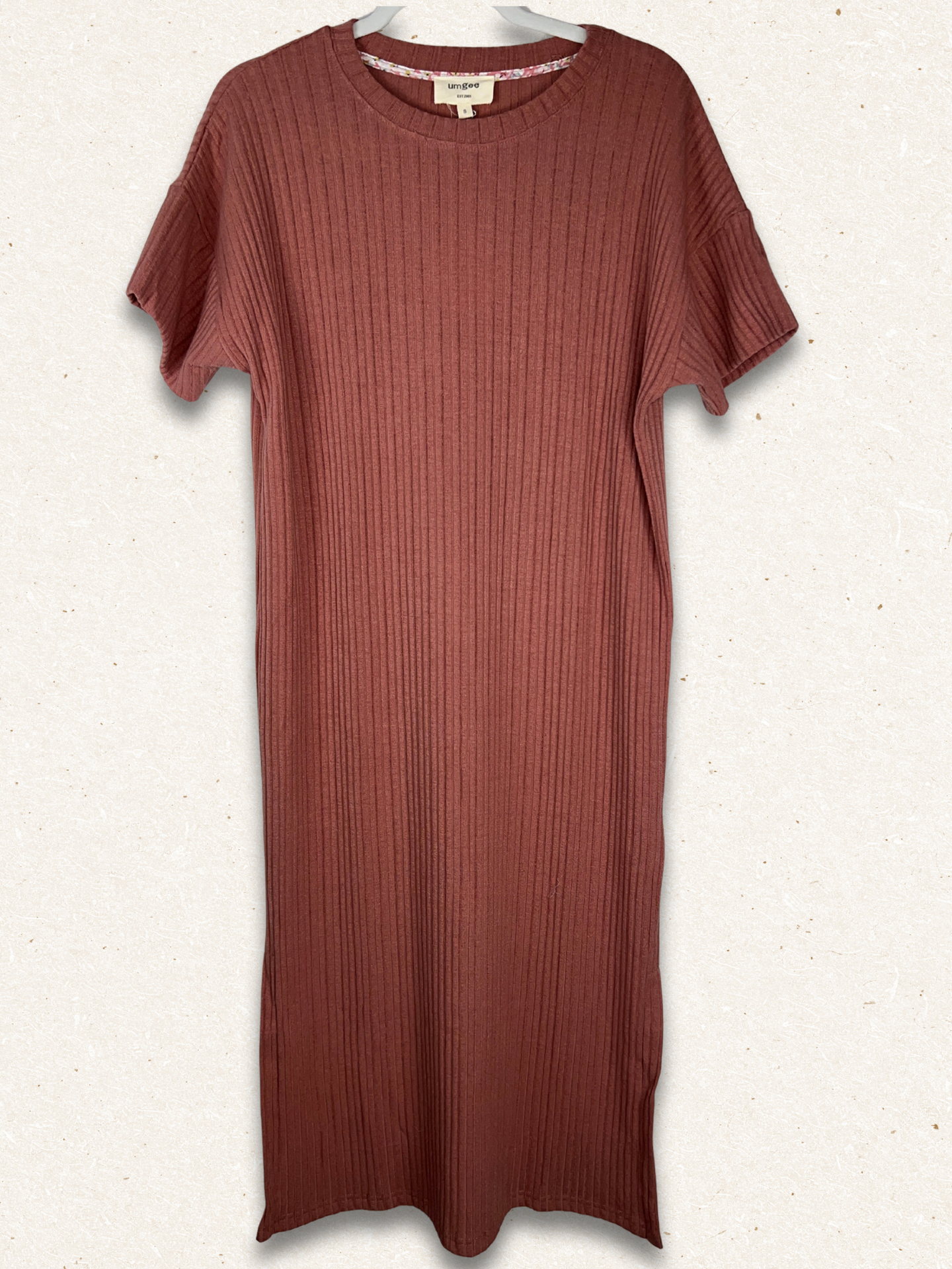 red dress with background that is textured and speckled white