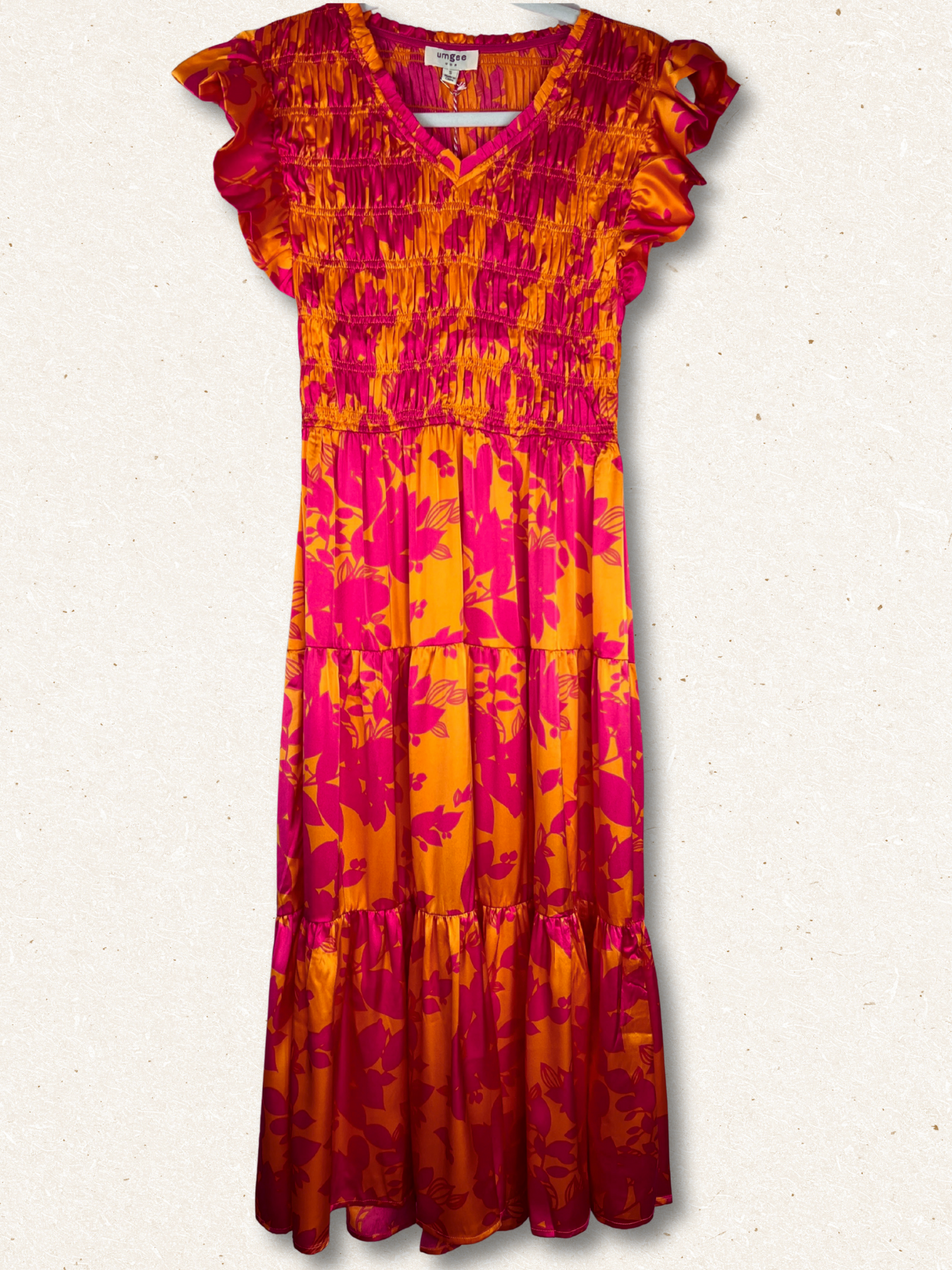 Colorful dress with pink and orange floral pattern on a white background