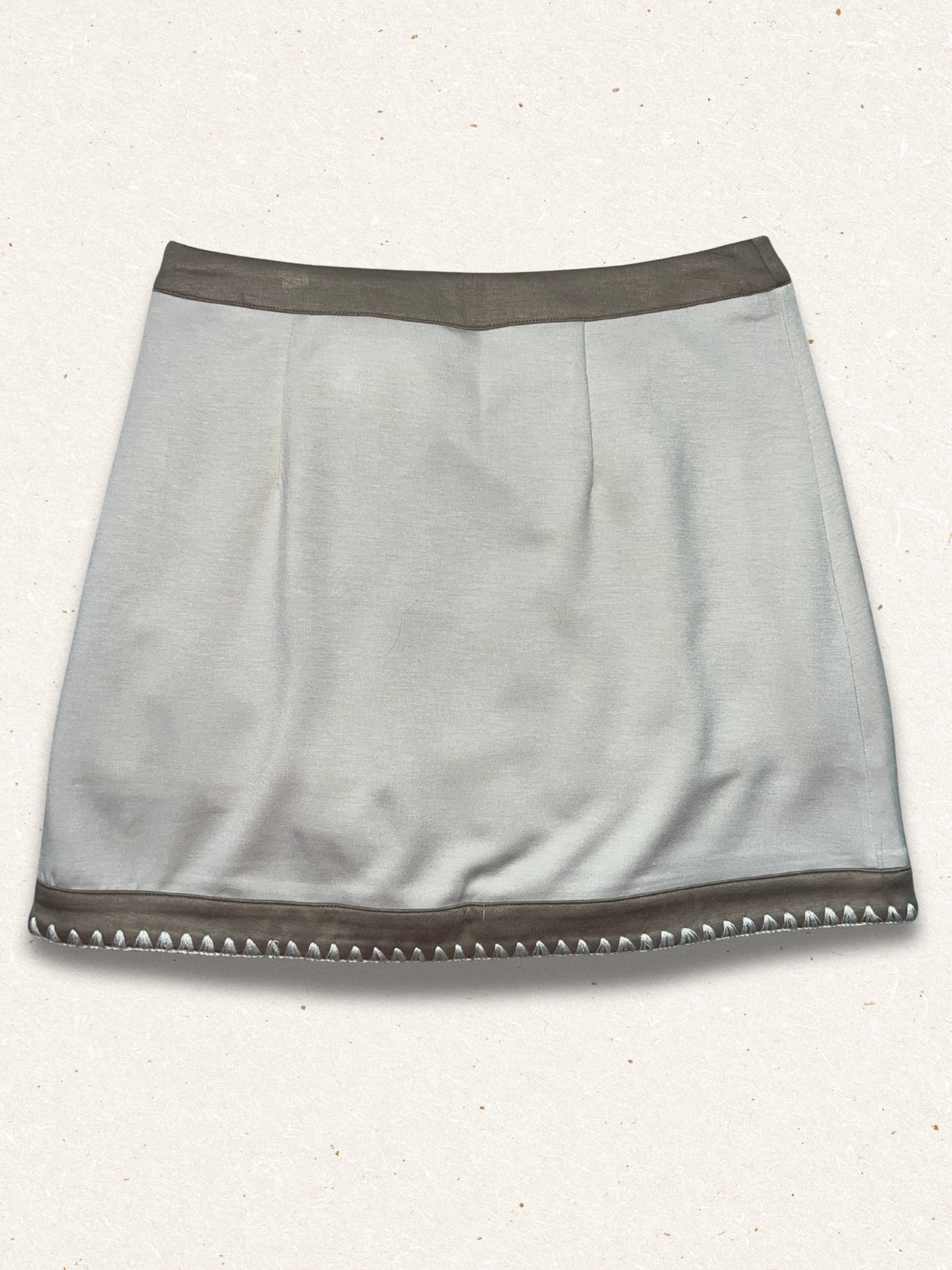 beige colored skirt with light speckled background