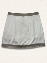 beige colored skirt with light speckled background