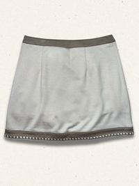beige colored skirt with light speckled background