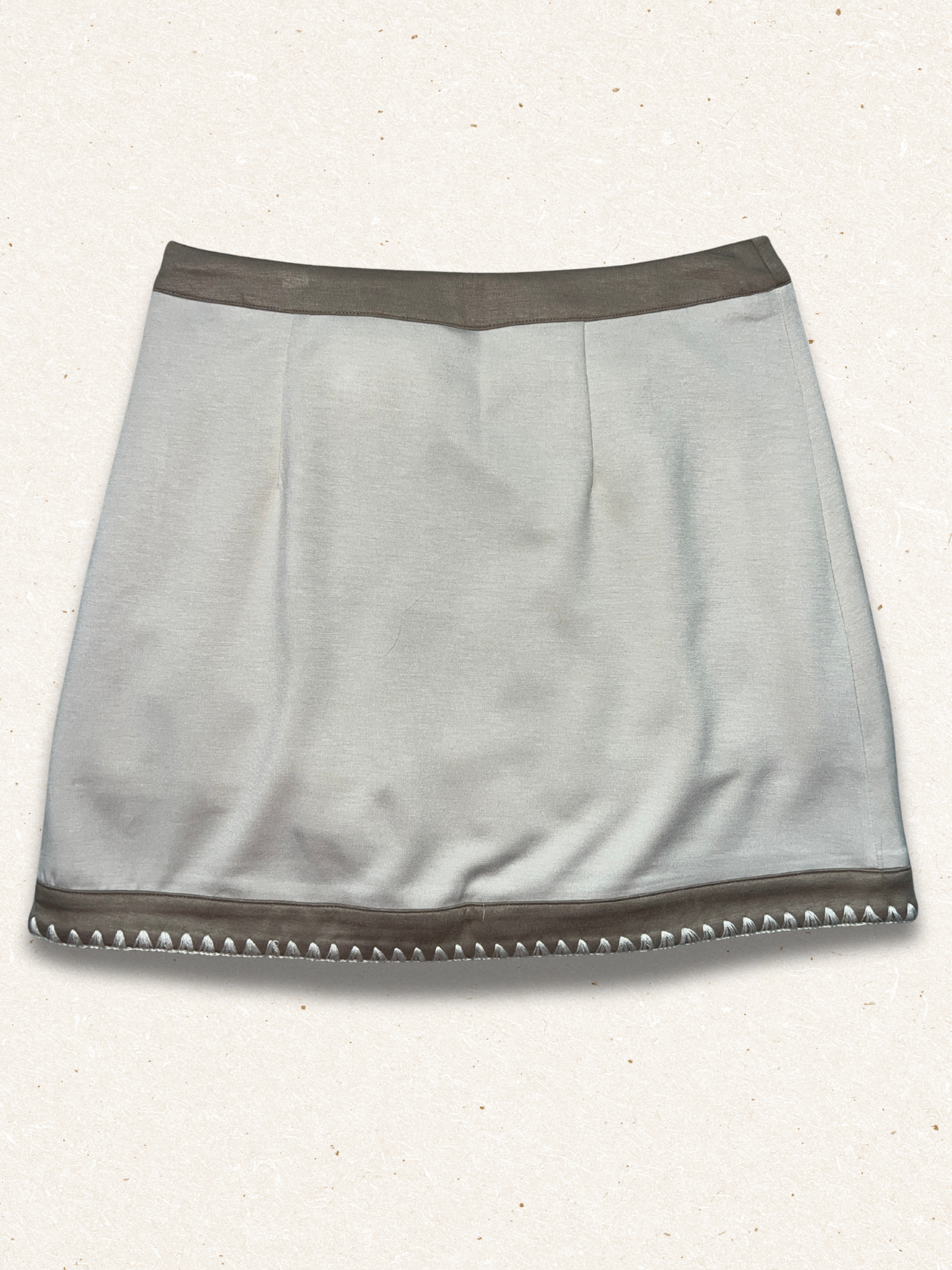 beige colored skirt with light speckled background