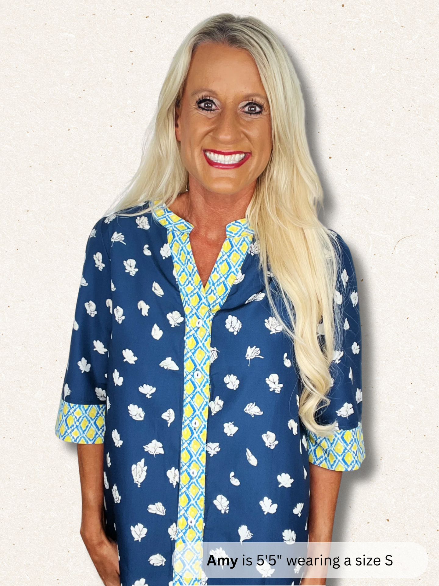 Woman wearing a blue patterned shirt with text indicating height and size.