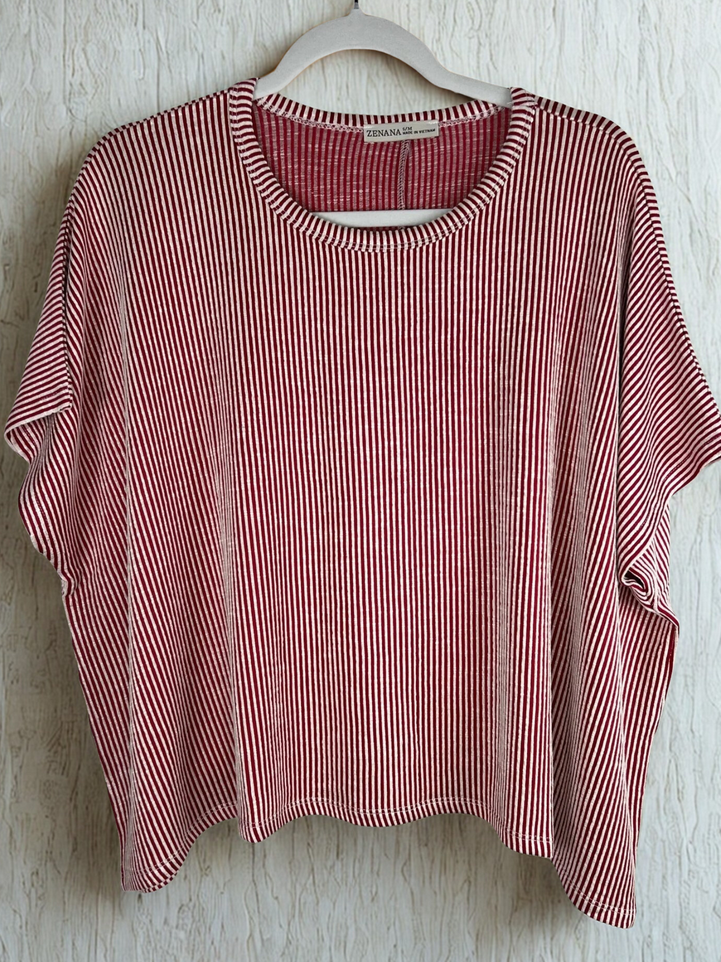 /Red/ red and white striped shirt with light beige background on a hanger