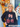 Woman wearing a black sweatshirt with Halloween-themed design in front of a decorated door.