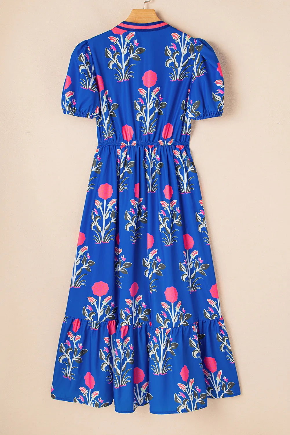 Blue dress with floral pattern on a beige background