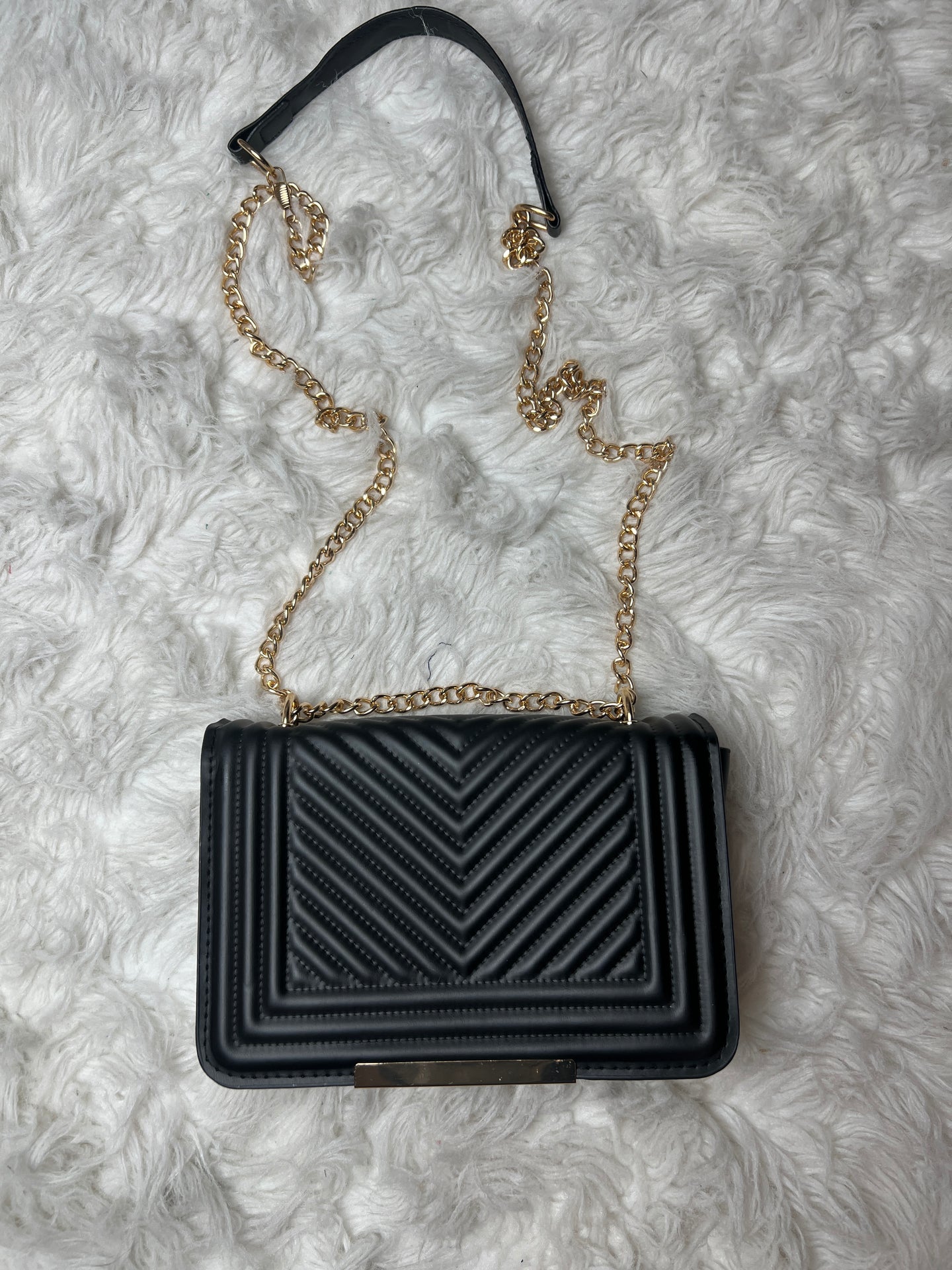 black bag on a white textured background