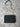 black bag on a white textured background